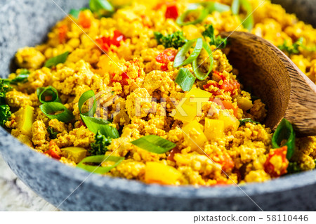 Tofu scramble with vegetables in a pan. Tofu scramble with vegetables in a pan. 58110446