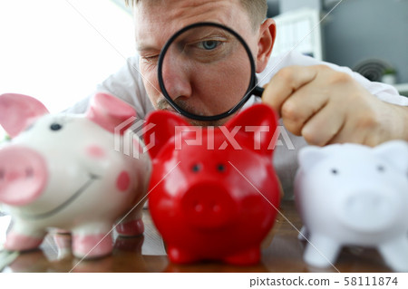 Male musinessman hold magnifying glass in hand 58111874