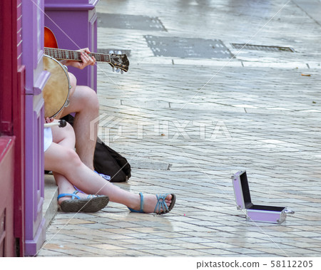 Unrecognizable street musicians, playing guitar, Unrecognizable street musicians, playing guitar, 58112205
