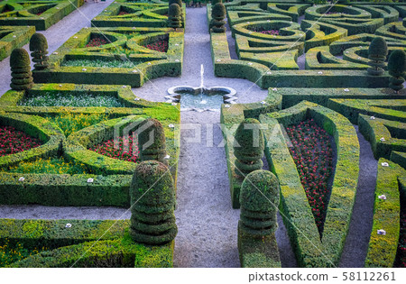 Colorful formal garden at sunset, with a 58112261