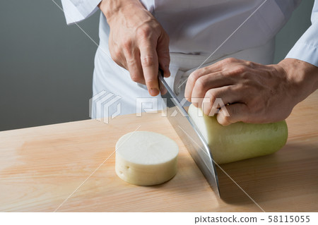 In front of a board to cut radish 58115055