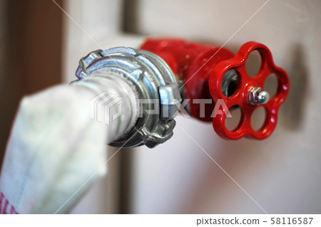 Connection of a fire hose with a red fire cock, Connection of a fire hose with a red fire cock, 58116587