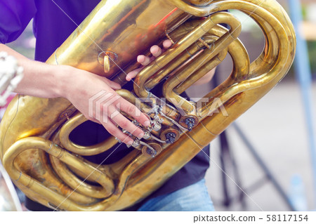 A tuba musician closeup in the city street 58117154