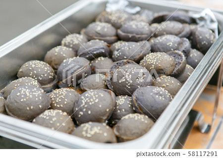 A closeup view of exotic black colored mini hamburger buns 58117291