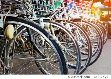 Row bicycle for rent.Old bicycle and detail of wheel Bicycle in line. Row bicycle for rent.Old bicycle and detail of wheel Bicycle in line. 58117477