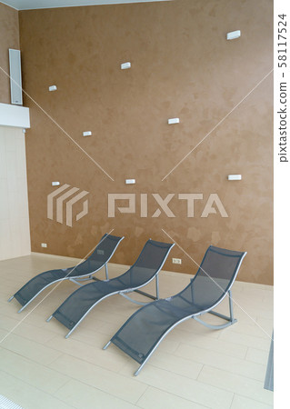 A three metal lounge chairs in empty room A three metal lounge chairs in empty room 58117524