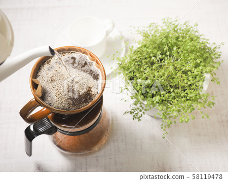 Drip coffee and coffee cup and houseplant Drip coffee and coffee cup and houseplant 58119478