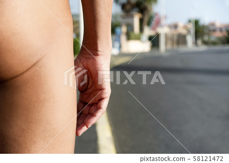 naturist man naked on the street 58121472