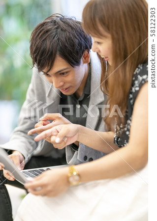 Single male businessman explaining presentation material to married female employee and seeing reaction Single male businessman explaining presentation material to married female employee and seeing reaction 58122303