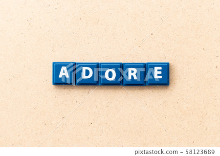 Tile letter in word adore on wood background Tile letter in word adore on wood background 58123689