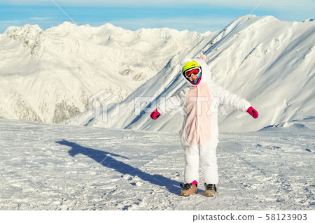 Cute adorable preschooler caucasian kid girl portrait with ski in helmet, goggles and unicorn fun 58123903