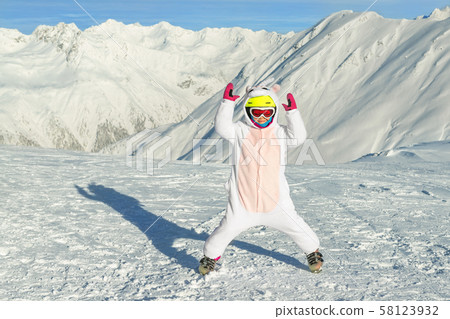 Cute adorable preschooler caucasian kid girl portrait with ski in helmet, goggles and unicorn fun Cute adorable preschooler caucasian kid girl portrait with ski in helmet, goggles and unicorn fun 58123932
