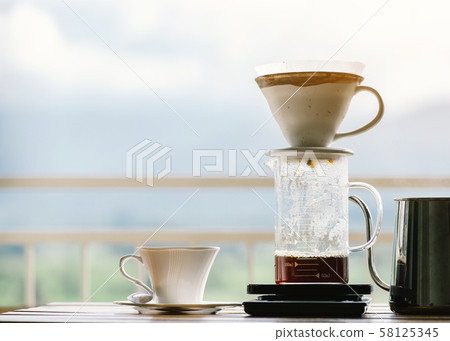 Cup of Dripping fresh hot coffee on the paper Cup of Dripping fresh hot coffee on the paper 58125345