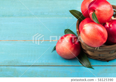 Sweet nectarine on wooden background Sweet nectarine on wooden background 58125390