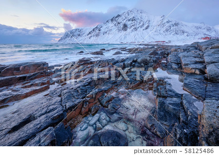 Coast of Norwegian sea on rocky coast in fjord on sunset 58125486