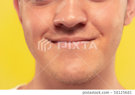 Caucasian young man's close up portrait on yellow background Caucasian young man's close up portrait on yellow background 58125681