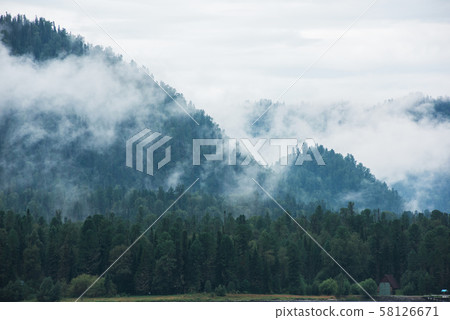 Little house in forested mountain slope 58126671