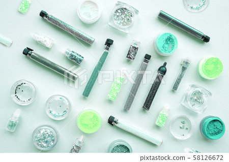 Sparkles in jars on a pink pastel background. 58126672