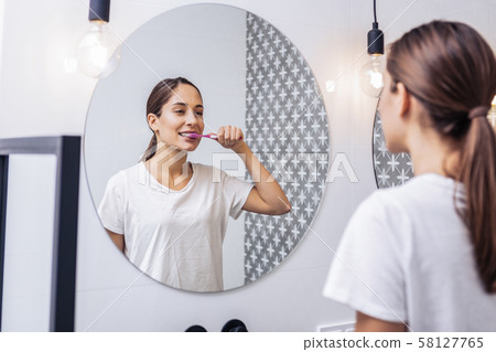 Young woman preparing for going to bed Young woman preparing for going to bed 58127765
