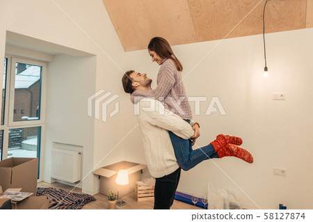 Young couple moving into new apartment together 58127874