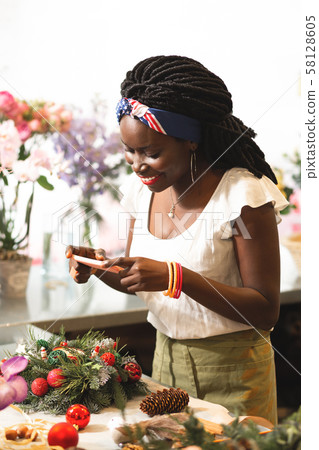 Positive delighted young woman taking picture on her gadget Positive delighted young woman taking picture on her gadget 58128605