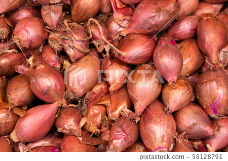 Pile of red organic onions in husk, may be used for background Pile of red organic onions in husk, may be used for background 58128791