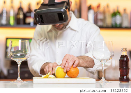 Barman apprentice preparing cocktail with virtual reality teacher. Apprentice learning how to 58128862