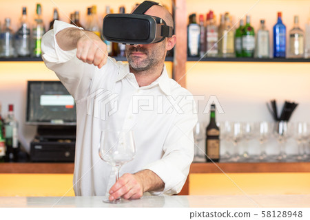 Barman apprentice training serving cocktail with virtual reality teacher. Apprentice learning how to Barman apprentice training serving cocktail with virtual reality teacher. Apprentice learning how to 58128948