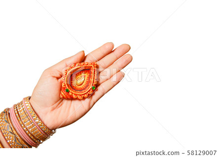 Happy Diwali - Woman hands with henna holding lit Happy Diwali - Woman hands with henna holding lit 58129007