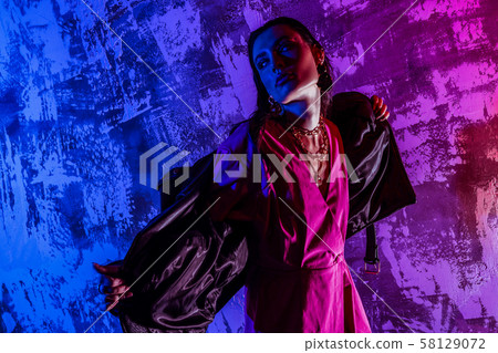 Gorgeous girl holding her leather jacket open 58129072
