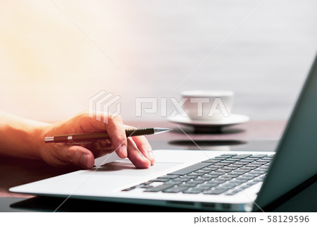 man using laptop computer working on new project idea at desk in office man using laptop computer working on new project idea at desk in office 58129596