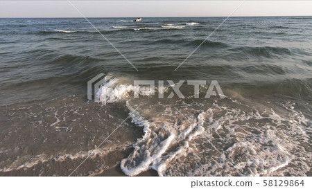 Wavy sea and clear sky in summer. 58129864