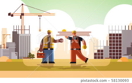 carpenter holding planks discussing with african american engineer workmen in uniform standing carpenter holding planks discussing with african american engineer workmen in uniform standing 58130093