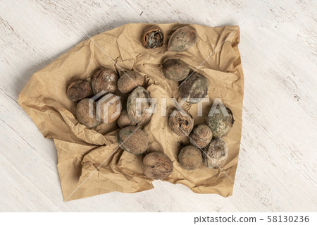 mouldy unpleasant walnuts as a background mouldy unpleasant walnuts as a background 58130236