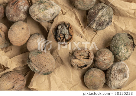 mouldy unpleasant walnuts as a background 58130238