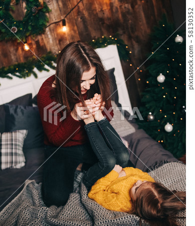 mom daughter indulge fun inside Christmas 58130352