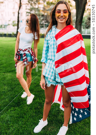Two stylish attractive girls with an American 58130745