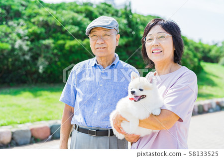 Senior couple (park, dog, pet, walk Senior couple (park, dog, pet, walk 58133525