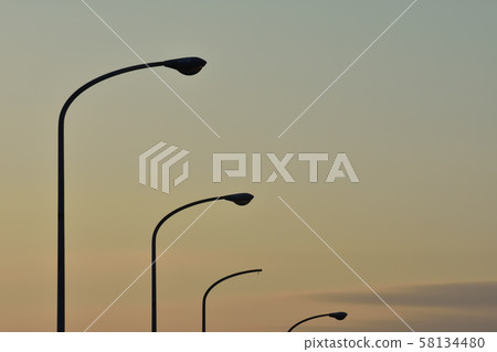 Sunset and street light Sunset and street light 58134480