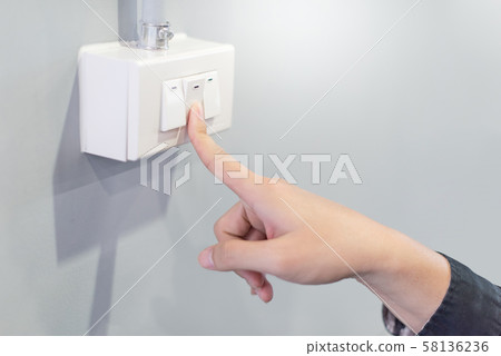 Male hand turning off the light. Energy saving Male hand turning off the light. Energy saving 58136236