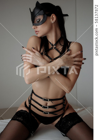 Brunette girl in a cat mask Brunette girl in a cat mask 58137872