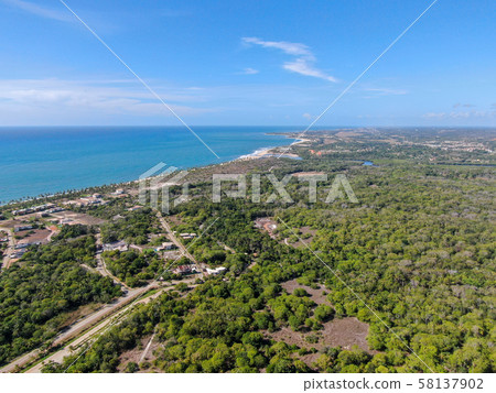 Aerial view of Praia Do Forte coastline town with 58137902