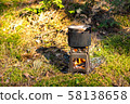 Pot boiling on twig stove outdoors 58138658