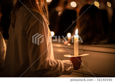 People handling candles in the hands. Christmas and lucia holidays 58140590