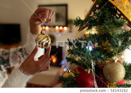 Woman at home at Christmas time Woman at home at Christmas time 58143282
