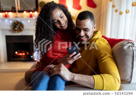 Couple at home at Christmas time 58143294