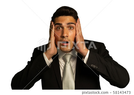 Young shocked businessman holding his head 58143473