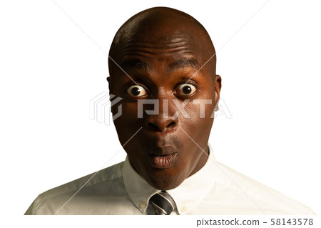 Young surprised businessman looking to camera 58143578