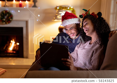 Couple at home at Christmas time 58143825