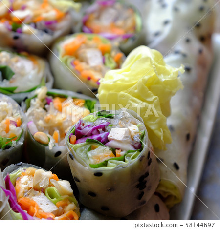 sliced vegan rice paper rolls and Vietnamese spring roll ingredient 58144697